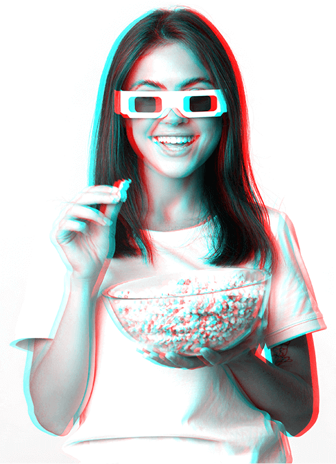 Person wearing red and cyan 3D glasses and holding popcorn